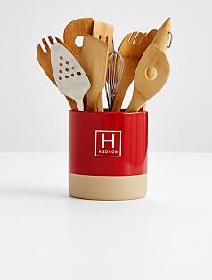 red stoneware utensil holder